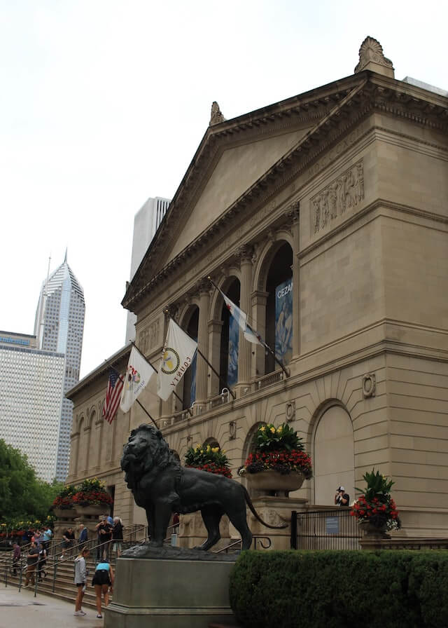 Exterior of the Art Institute of Chicago, a life size iron lion sculpture flanks the entrance 