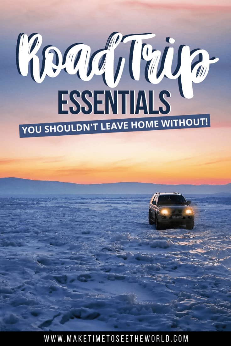 Road Trip Packing list pin image featuring a 4 wheel drive car sitting on a snowy expanse with it's headlights on facing the camera. Behind is an orange glow of a sunset when it meets the earth rising to a purple shade above. The image has a text overlay which states 'Road Trip Essentials you shouldn't leave home without'