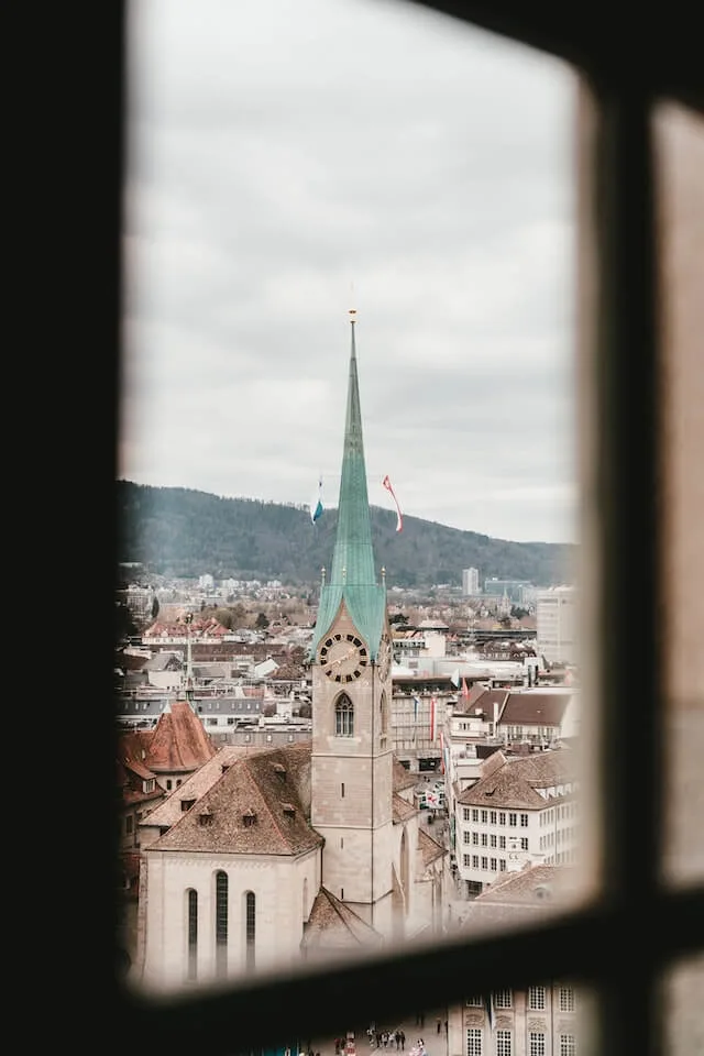 Gothic Green spire of the fraumunster church in Zurich as seen from a window in a high building