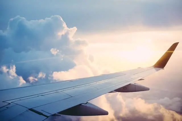 Airplane wing in the clouds viewed from a plane window 