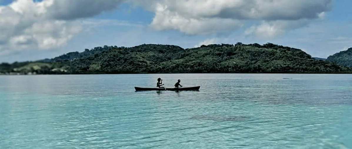 Solomon Islands People - Two People of Solomon Islands in a Canoe