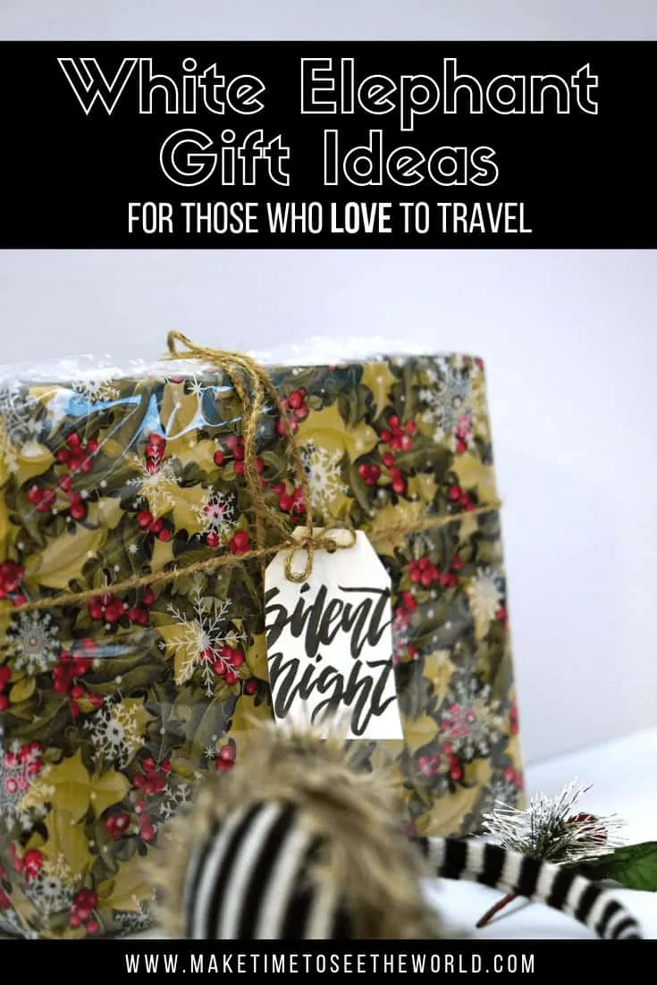 Pin Image with the title: White Elephant Gift Ideas for those who love to travel overlayed on an image of a square wrapped gift with a tag saying silent night and a pair of zebra striped earmuffs with a christmas bow on them at the front of the shot