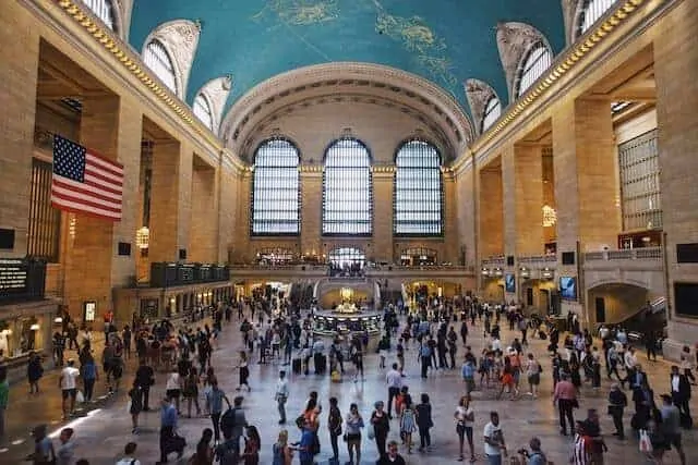 Grand Central Terminal Building with domed roof, shiny concrete floor covered in people moving through