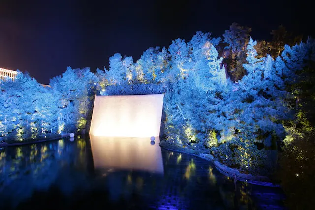 Waterfall in the centre of the lake of dreams surrounded by white fir trees