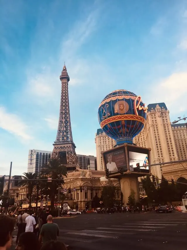 Paris Hotel & Casino, the replica Eiffel Tower in the background and the blue hot air balloon in the foreground bearing the word 'Paris'
