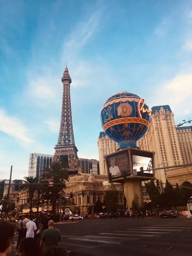 View across lake to replica Eiffel Tower at the Paris Hotel and Casino,  Bellagio fountains in