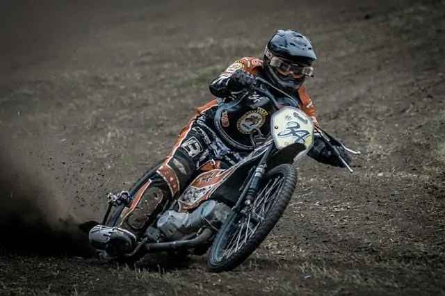 Man riding a speedway bike around the dirt track