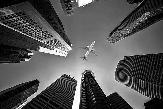 Plane in the Sky between buildings