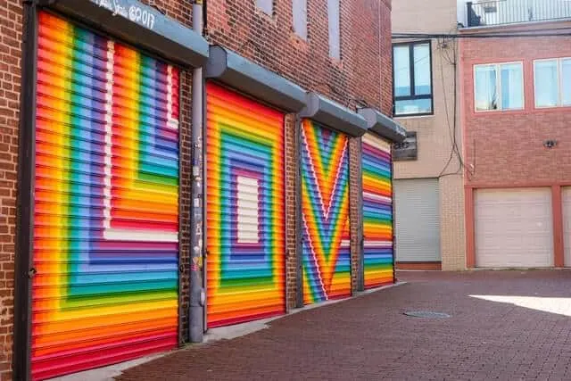 Rainbow coloured LOVE on closed shop shutters