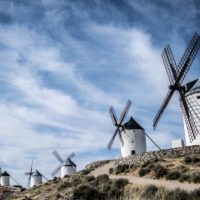 Best Places to Visit in Spain Header Image of the White windmills on top of the hill at Consuegra, Spain