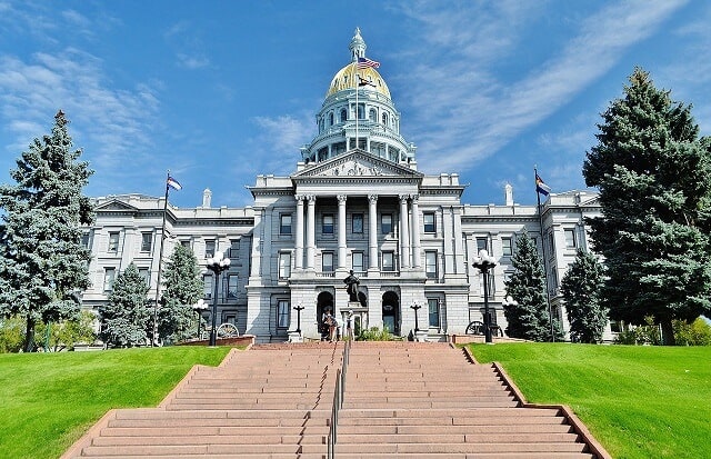 Steps leading up to the white domed 4 double storu Capitol Building in Denver Colorado