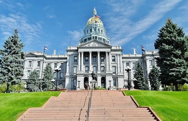 Steps leading up to the white domed 4 double storu Capitol Building in Denver Colorado