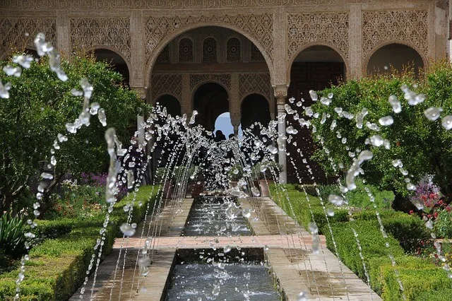 Water fountains bubbling in front of the domed archways inside the Palacio de Generalife in Granada