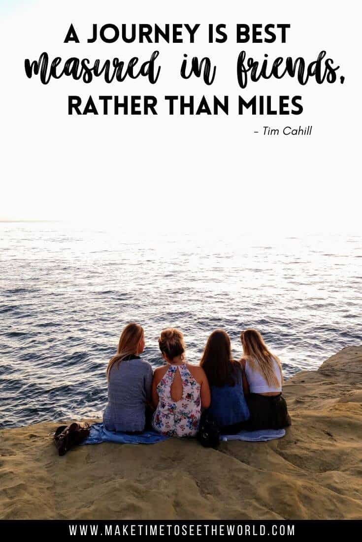 4 Female firends sat in a line with their backs to the camera on a cliff top overlooking the ocean with text overlay staing: A Jourey should be measured in friend rather than miles 