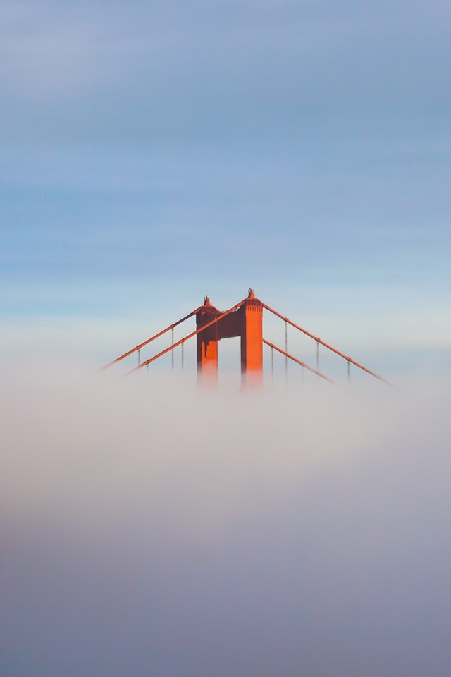 Karl the Fog hovering over the Golden Gate Bridge, only the top of the red bridge visible