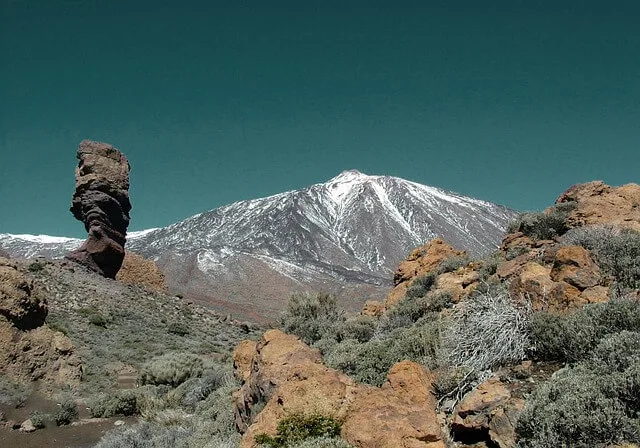 Rocky landscape looking up towards the snow covered peak of Mount Teide in Tenerife
