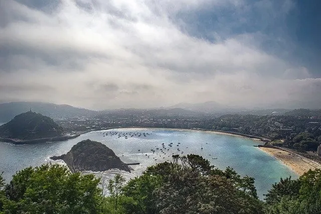 Aerial view of the Bay at San Sebastian Spain with boats in the water and deck chairs on the beach