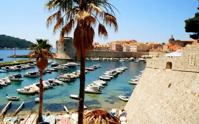 The Harbour with lines of small fishing boats tied up in a line in the water