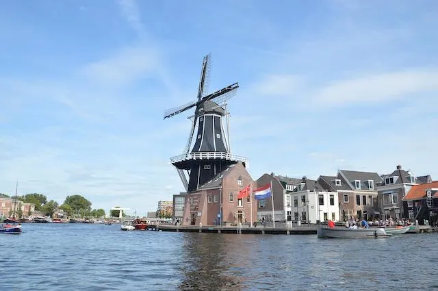 Windmill on the riverbank known as Molen de Adriaan in Haarlem Netherlands