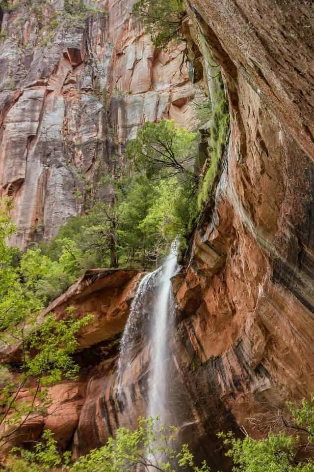 Waterfall falling from the high rock face which forms the Lower Emerald Pools.