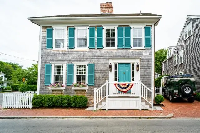 Stunning Double storey hose with turquoise shutters, white windows and raised galley entryway