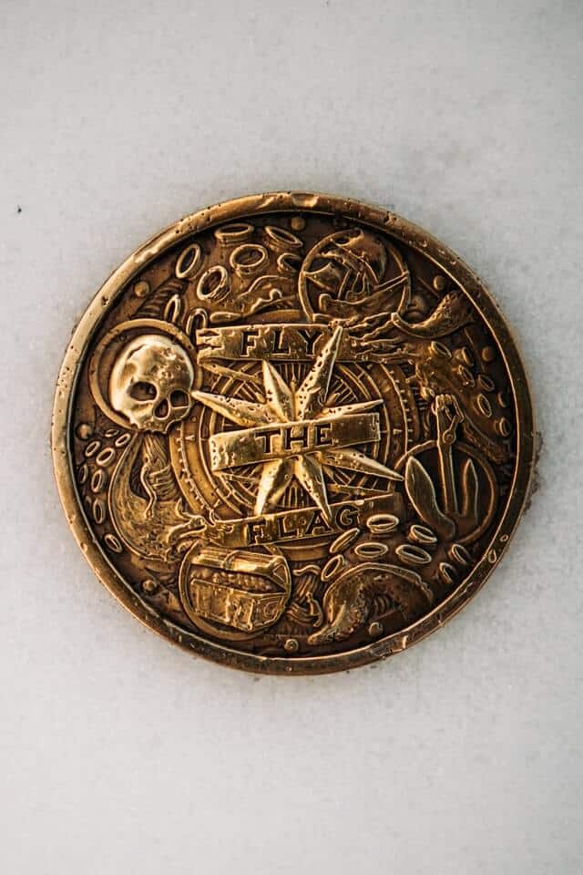 Gold Pirate coin on a white table