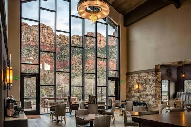 Three story windows looking out on the mountains of Zion National Park in the dining room of Springhill Suites by Marriott