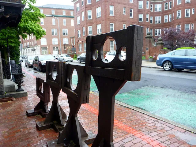 4 different height wooden stocks outside the Witch Dungeon Museum Salem