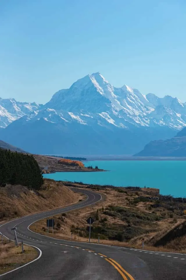 Winding road driving towards a lake in New Zealand