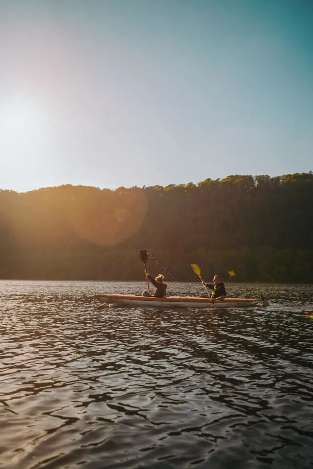 A double kayak being paddled by two people on Huron River