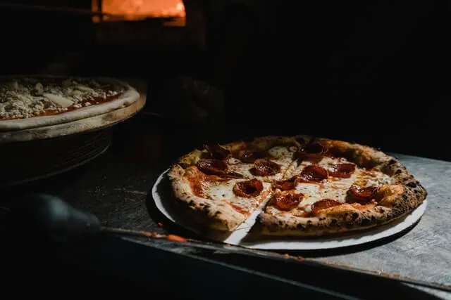 Woodfired Pepperoni Pizza, the oven in the background glowing