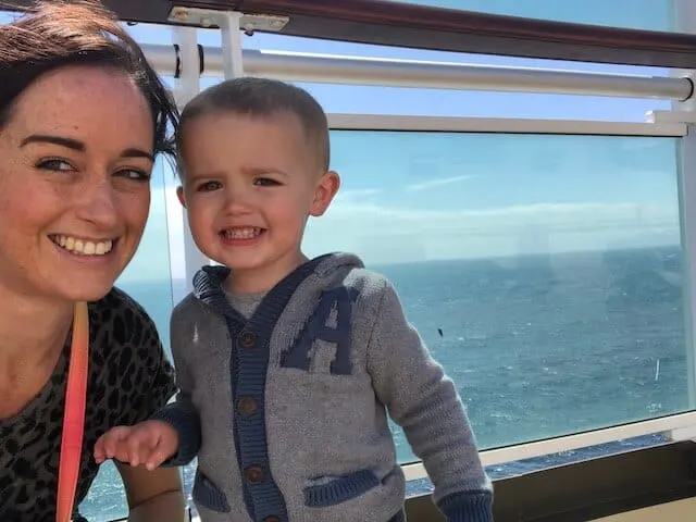Jenni and two-year-old Adam in front of a cruise ship balcony