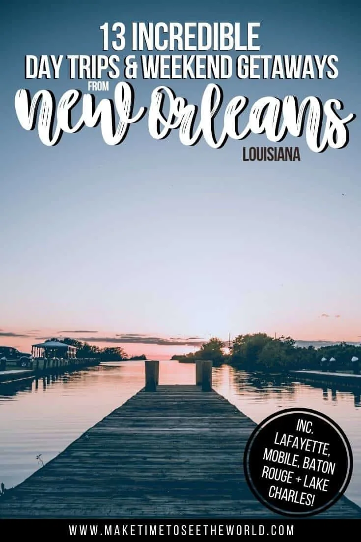 13 Day Trips from New Orleans Weekend Getaways pin image of a wooden pier leading out to a lake, flanked by small islands at dusk, the water reflecting a slight pink colour