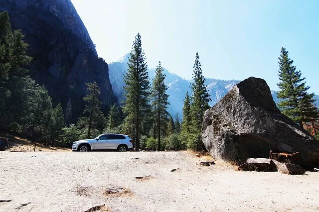 Car parked at the side of a road in a national park