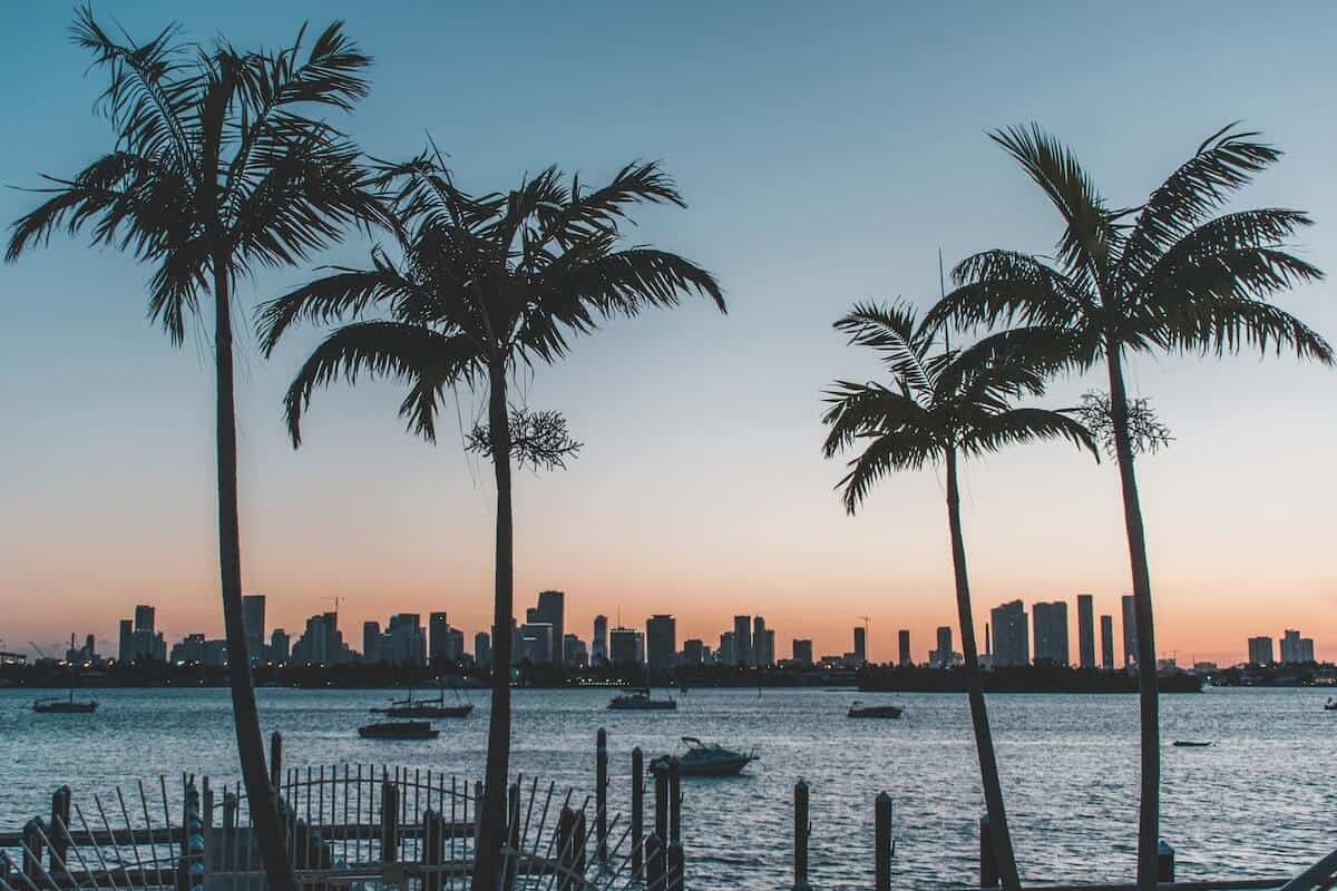 Fun Things to do in Miami Florida cover photo of the Miami skyline viewed from across the water at sunset