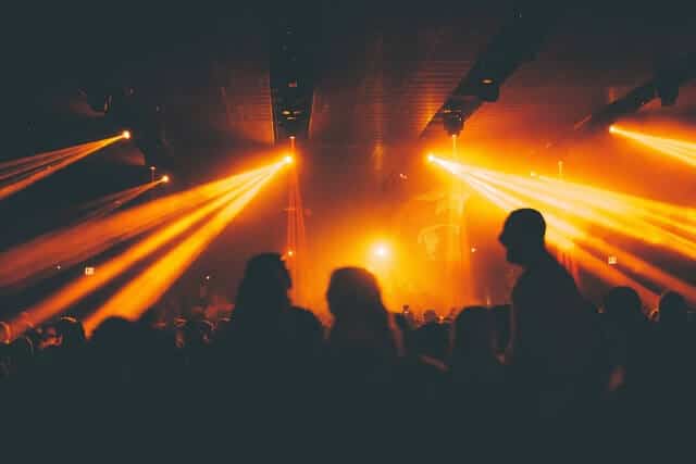 Busy nightlub with yellow-orange strobe lights