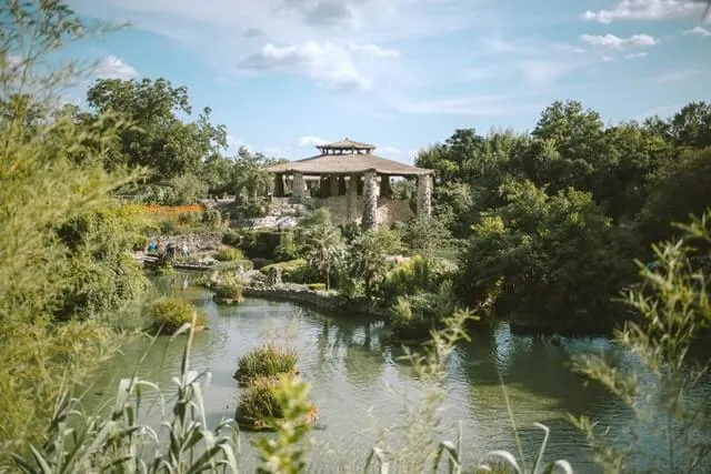 Japanese style gardens with pagoda, river and various shrubs and trees all around