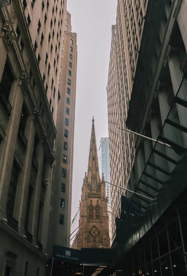 Spire of Trinity Chruch between sky scrapers in New York