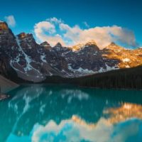 Things to do in Banff in Summer cover image of an Emerald Lake with a rocky mountain backdrop under a blue sky