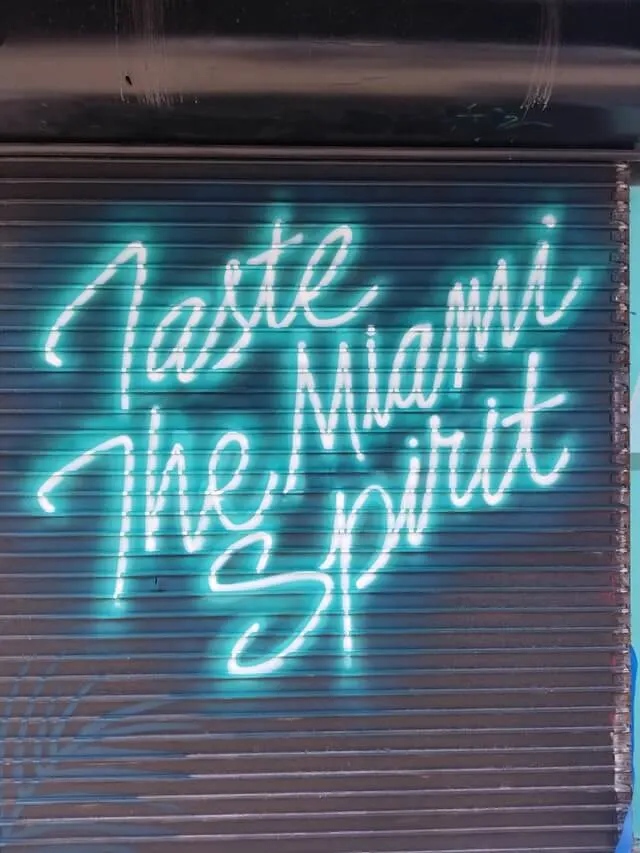 Where to eat in Miami Florida - Neon graffiti sign stating 'Tatse the Spirit of Miami'