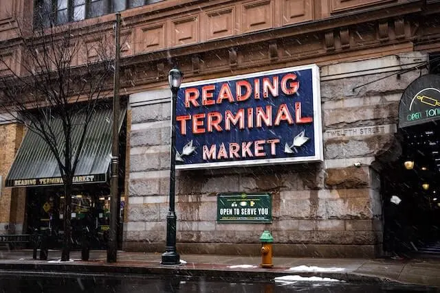 Neon sign of the Reading Terminal Market on a Stone Wall
