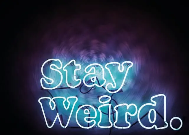 Neon 'Stay Weird' sign light up in blue/purple in Philadelphia