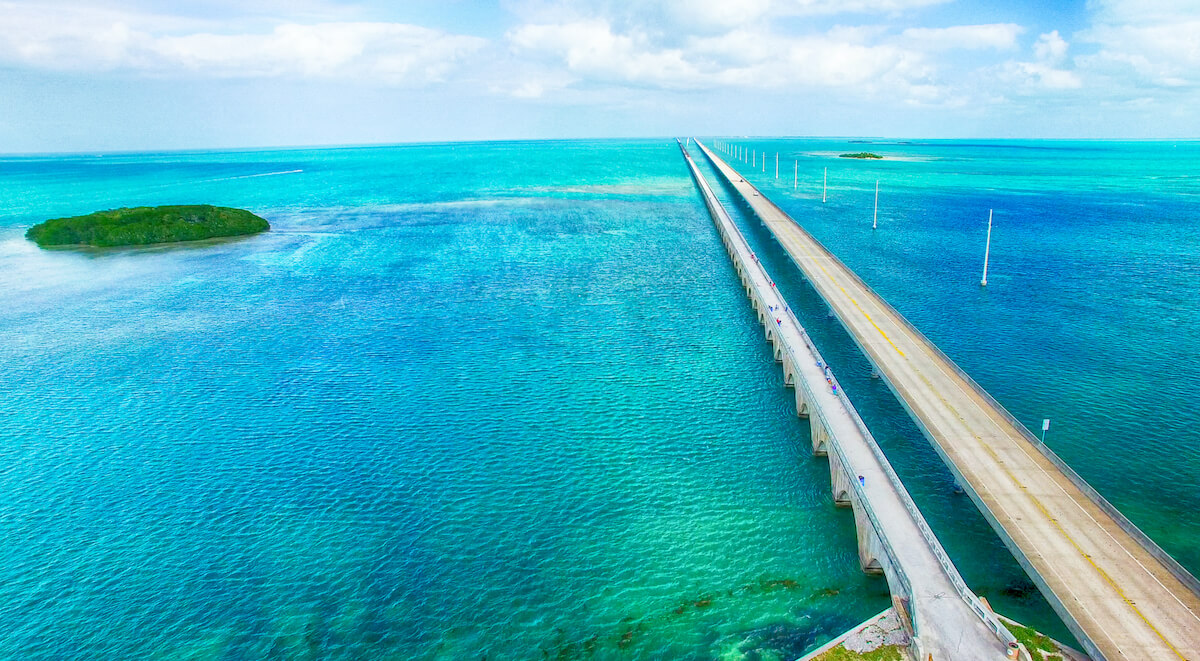 Best Road Trips in Florida cover photo of the Seven Mile Bridge streching over the ocean in the Florida Keys