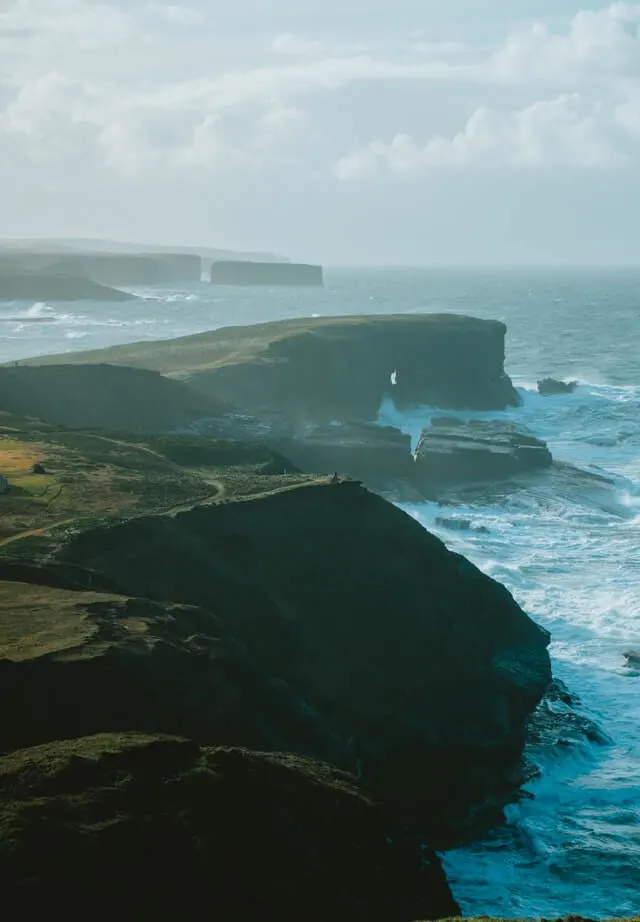 Rocky coastline with waves crashing into the cliffside on the Wild Atlantic Way in Iceland