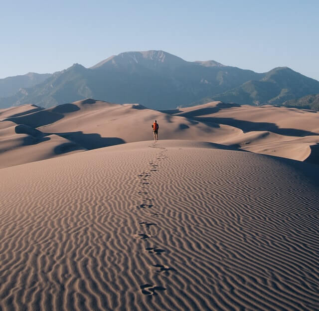 Man standing on sand in the desert