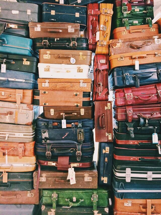 Stacks of vintage suitcases in multiple different colours