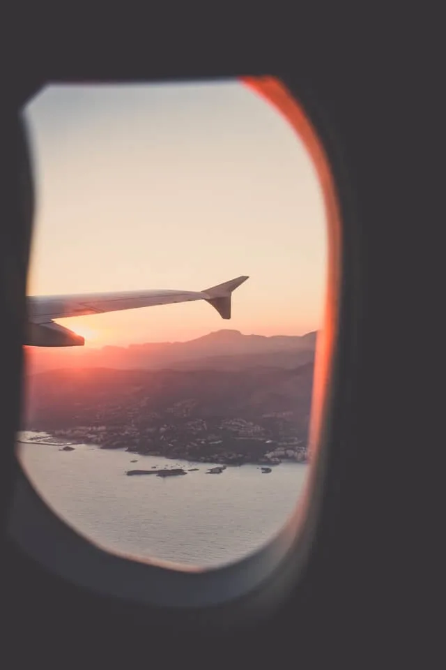 View out of a plane window looking along the wong, at sunset