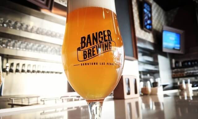 Banger Brewing Branded Glass filled with beer sitting on the bar