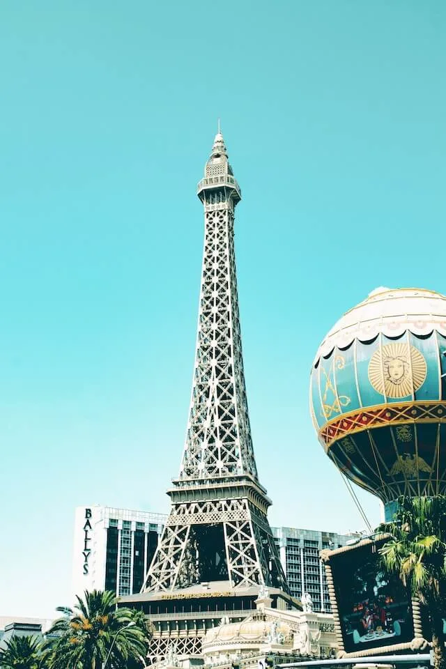 View across lake to replica Eiffel Tower at the Paris Hotel and Casino,  Bellagio fountains in