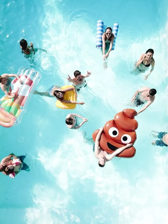 Pool Party with multiple people in the swimming pool on different inflatables